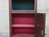 a wooden cabinet with a door open on the floor