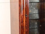 a large wooden cabinet with a mirror on top of it