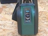 a green and black camera sitting on top of a wooden floor
