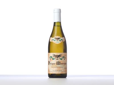 a bottle of white wine sitting on top of a table