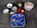 a blue and white plate and bowls and spoons on a table