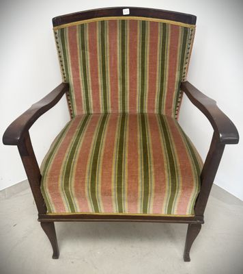an old chair with striped upholstered upholstered seat