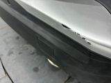 a close up of a car ' s bumper with a hole in it