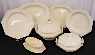 a lot of white plates and bowls on the table