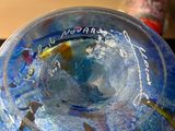 a glass bowl with a fish inside of it on a table