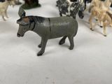 a lot of toy animals that are on a table