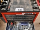 a lot of tools in a tool box on the floor