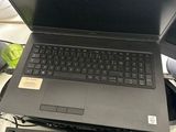 a laptop computer sitting on top of a desk next to a keyboard