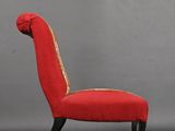 pair of red upholstered chairs in the style of a horse