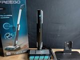a box with a vacuum and a mop on a table