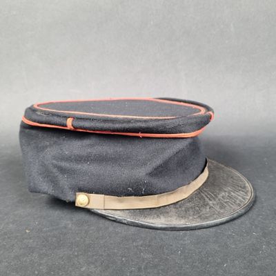 a close up of a hat on a table with a gray background