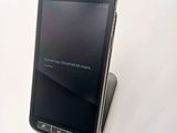 a cell phone that is sitting on top of a stand
