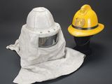 yellow fireman ' s helmet and a yellow fireman ' s hat on a black background