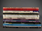 many books stacked on top of each other on a table