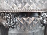 a silver vase sitting on top of a table