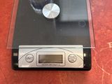 a glass of wine sitting on top of a digital scale