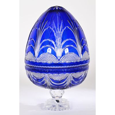 an image of a blue glass egg shaped box on a clear base