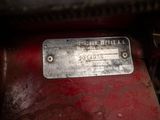 a close up of a metal plate on a red vehicle
