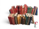 many old books stacked in a circle on a white surface