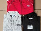 three adidas tracksuits and a t - shirt on a cardboard box