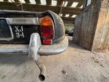 a car that is parked in a garage with its tail light on