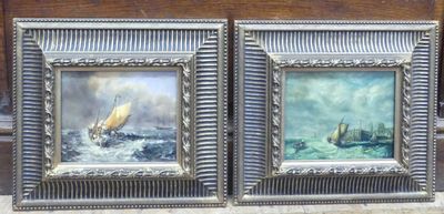 two framed pictures of boats on the water on the wall
