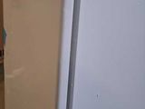 a white refrigerator sitting on a pallet in a warehouse
