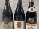 three bottles of wine are lined up on a table