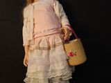 a doll that is standing next to a basket and shoes