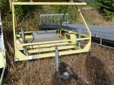 a yellow trailer that is parked in the grass