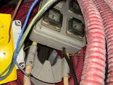 a close up of a red and black hose and wires