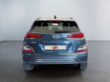 the rear of a blue car is parked in a white room
