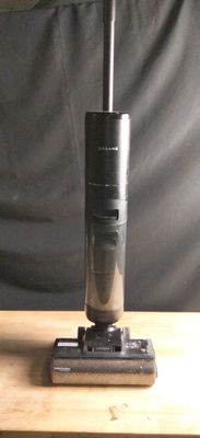 a vacuum that is sitting on a wooden table