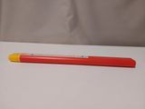 a red pencil with a yellow tip on a white table
