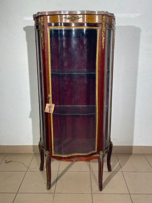 a display case with a glass door in a room