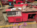 a red machine that is sitting in a warehouse