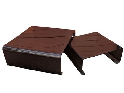 pair of coffee tables made of wood and metal with a glass top