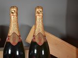 three bottles of champagne sitting on top of a wooden table
