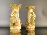 two vases that are sitting on a table