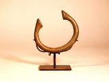 an image of a bronze sculpture of a fish on a wooden base