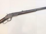 a rifle with a wooden barrel and a wooden handle