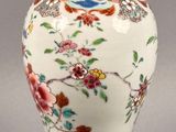 a vase with a lid that has flowers and birds on it