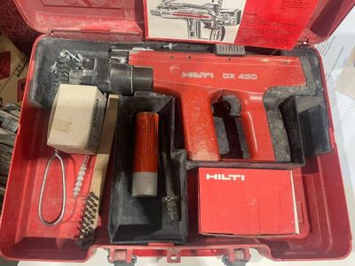 a red tool case with tools in it on a table