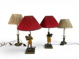 three lamps that are on a table with a red shade
