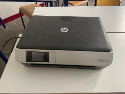 laptop sitting on top of a desk in a classroom