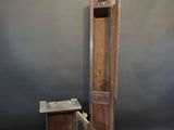 a tall wooden grandfather clock next to a small table