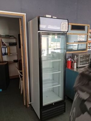 a refrigerator that is sitting in the corner of a room