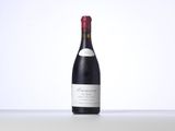 the bottle of wine is sitting on the table with a white background