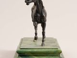 statue of a horse on a marble base on a white background