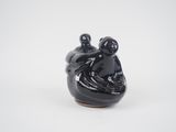 black ceramic figurine of a man and a woman sitting on a boat
